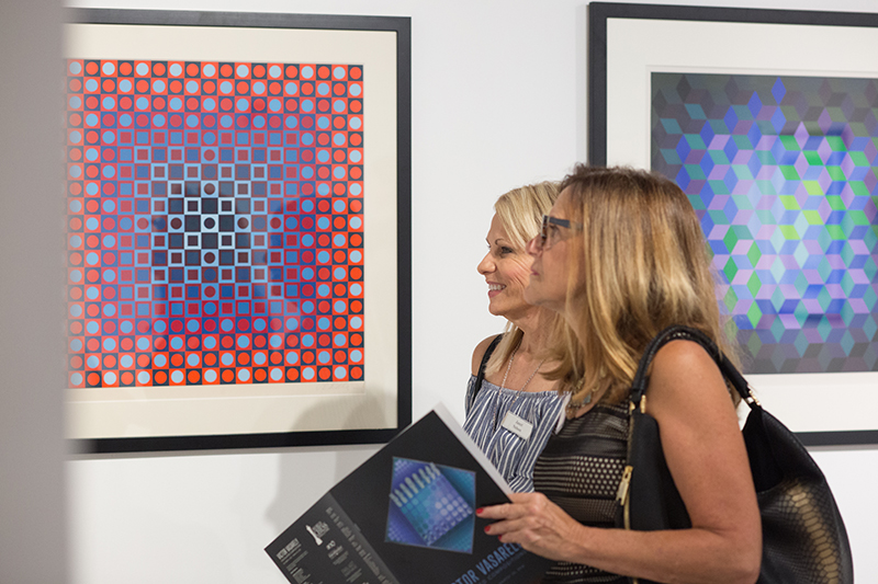 Guests view the exhibition Victor Vasarely: Calculated Compositions at the World Chess Hall of Fame