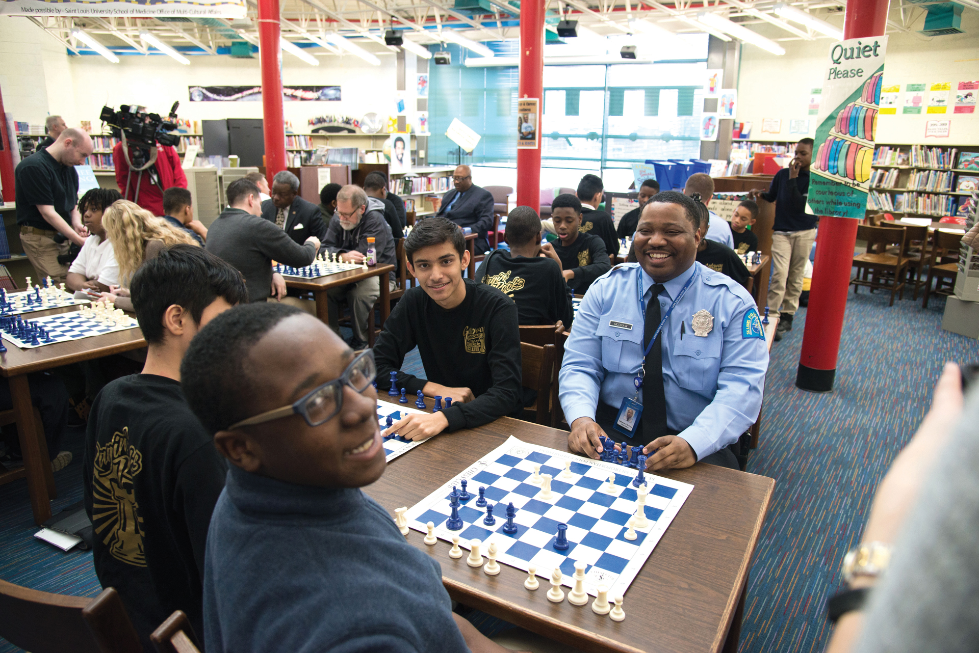 Officer Nate McGraw enjoying a chess game with St. Louis Public School students.