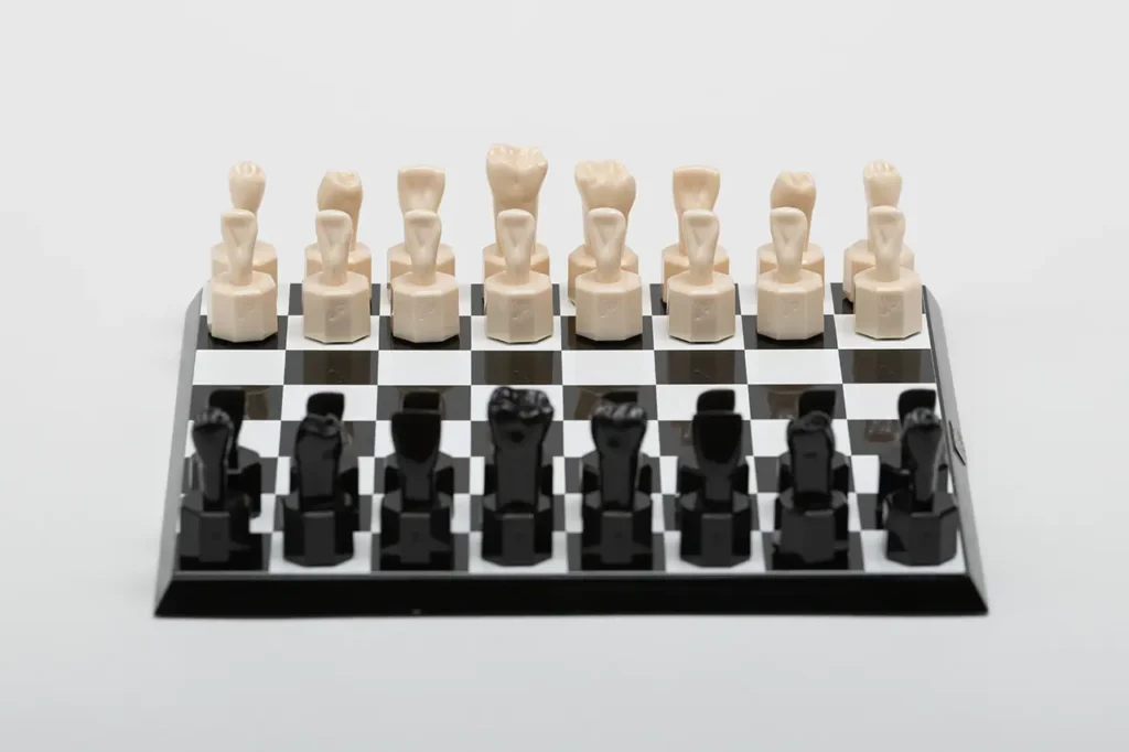 Close-up of the unique Teeth Chess Set from the World Chess Hall of Fame & Galleries, featuring human teeth-shaped pieces on a chessboard.