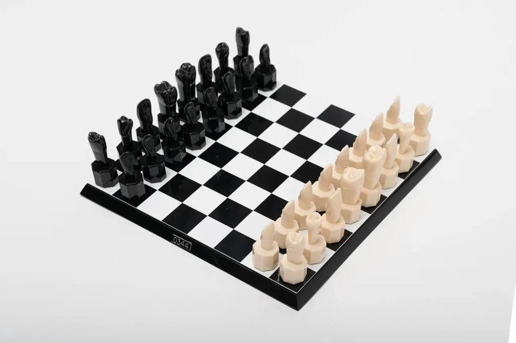 Close-up of the unique Teeth Chess Set from the World Chess Hall of Fame & Galleries, featuring human teeth-shaped pieces on a chessboard.