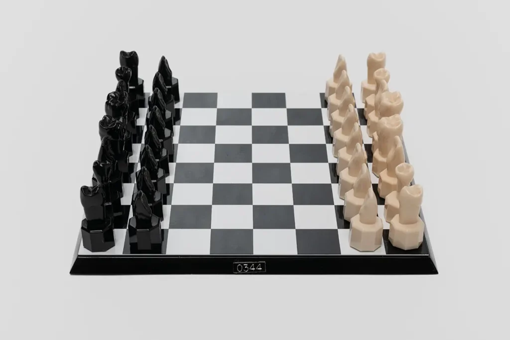 Close-up of the unique Teeth Chess Set from the World Chess Hall of Fame & Galleries, featuring human teeth-shaped pieces on a chessboard.