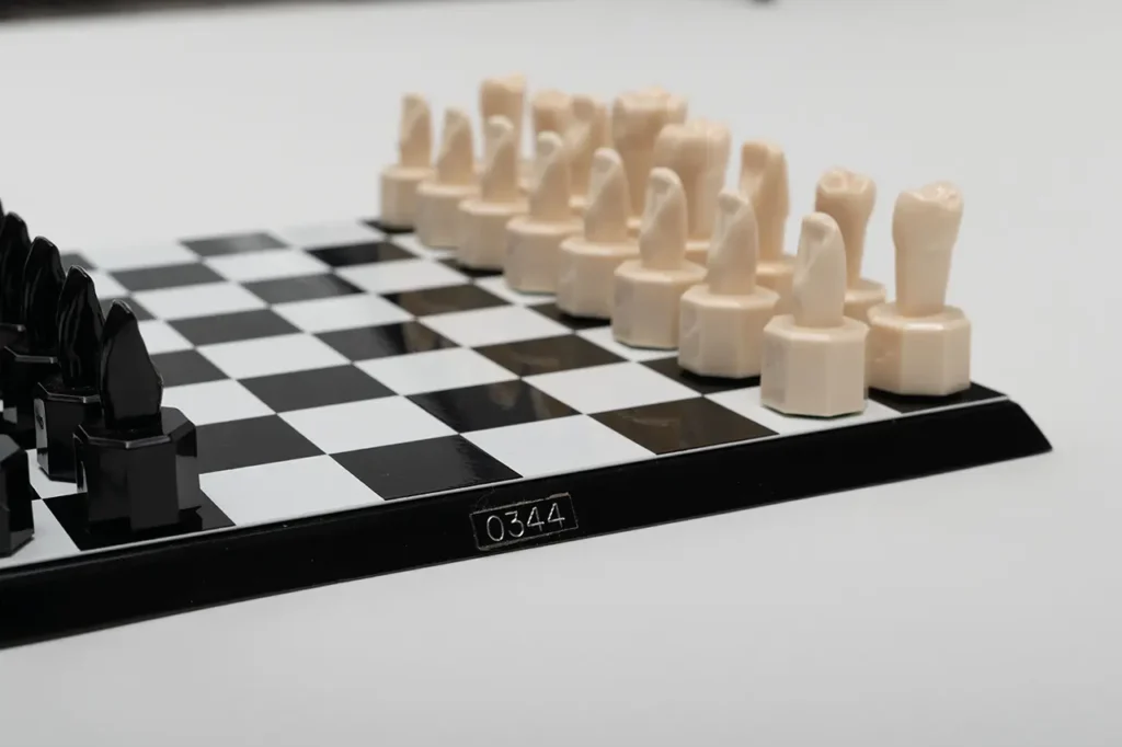 Close-up of the unique Teeth Chess Set from the World Chess Hall of Fame & Galleries, featuring human teeth-shaped pieces on a chessboard.