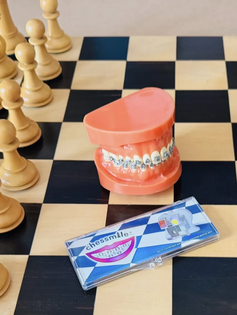 photo - Chessmile Chessmile Brackets, Dental Model, and Promotional Items c. 2009 Plastic, metal, paper, and nylon Collection of the World Chess Hall of Fame & Galleries, gift of Dr. Carolina Blanco