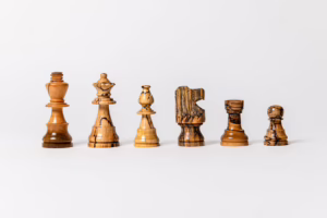 The Monticello Chess Set, intricately crafted from historic wood grown at Thomas Jefferson's estate, displayed on a matching wooden board.