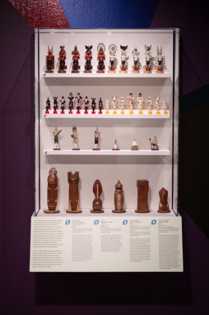 Glass display case featuring four Munger donation chess sets in the Crown Jewels exhibition.
